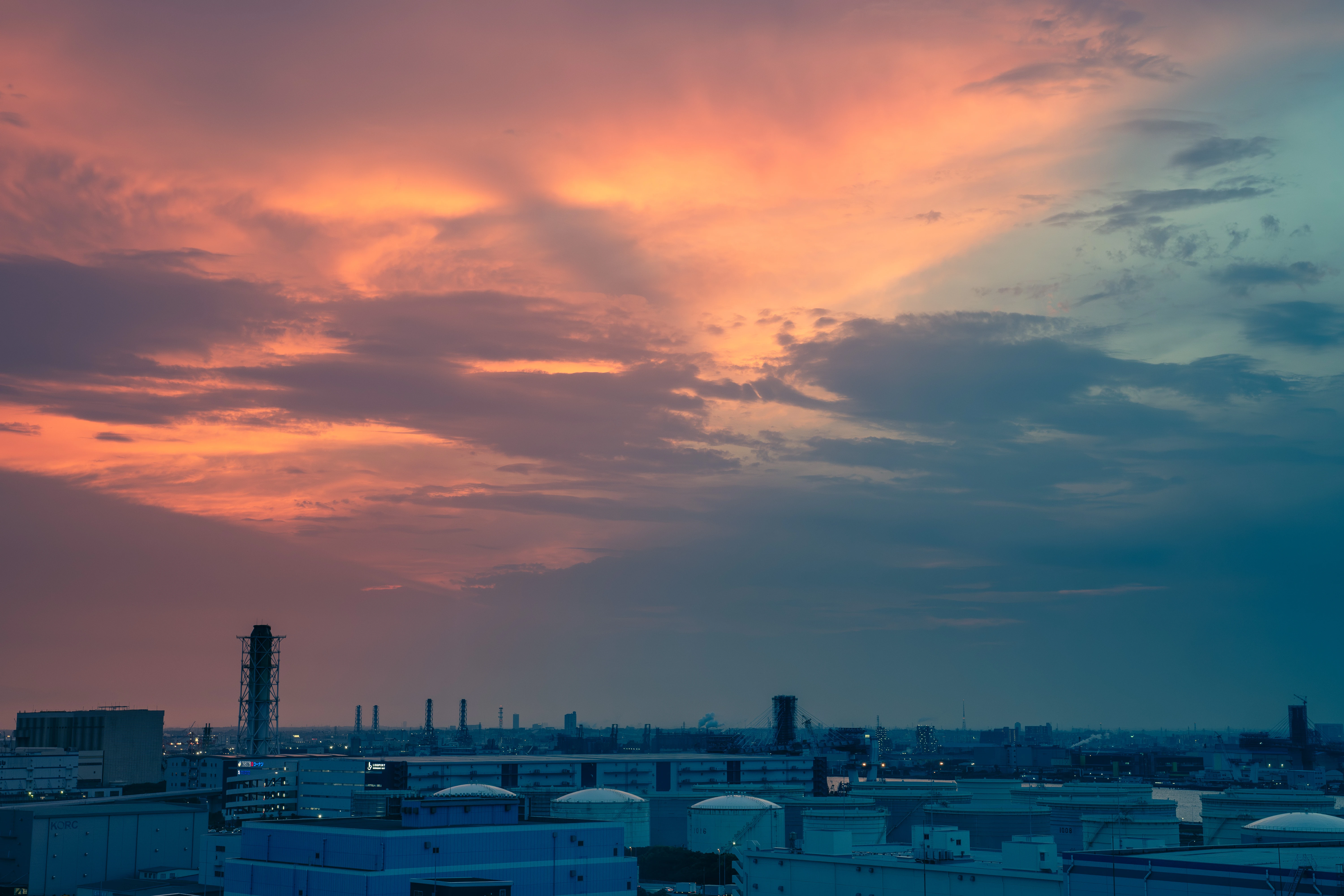Industrial Skyline Under a Fiery Sunset Glow