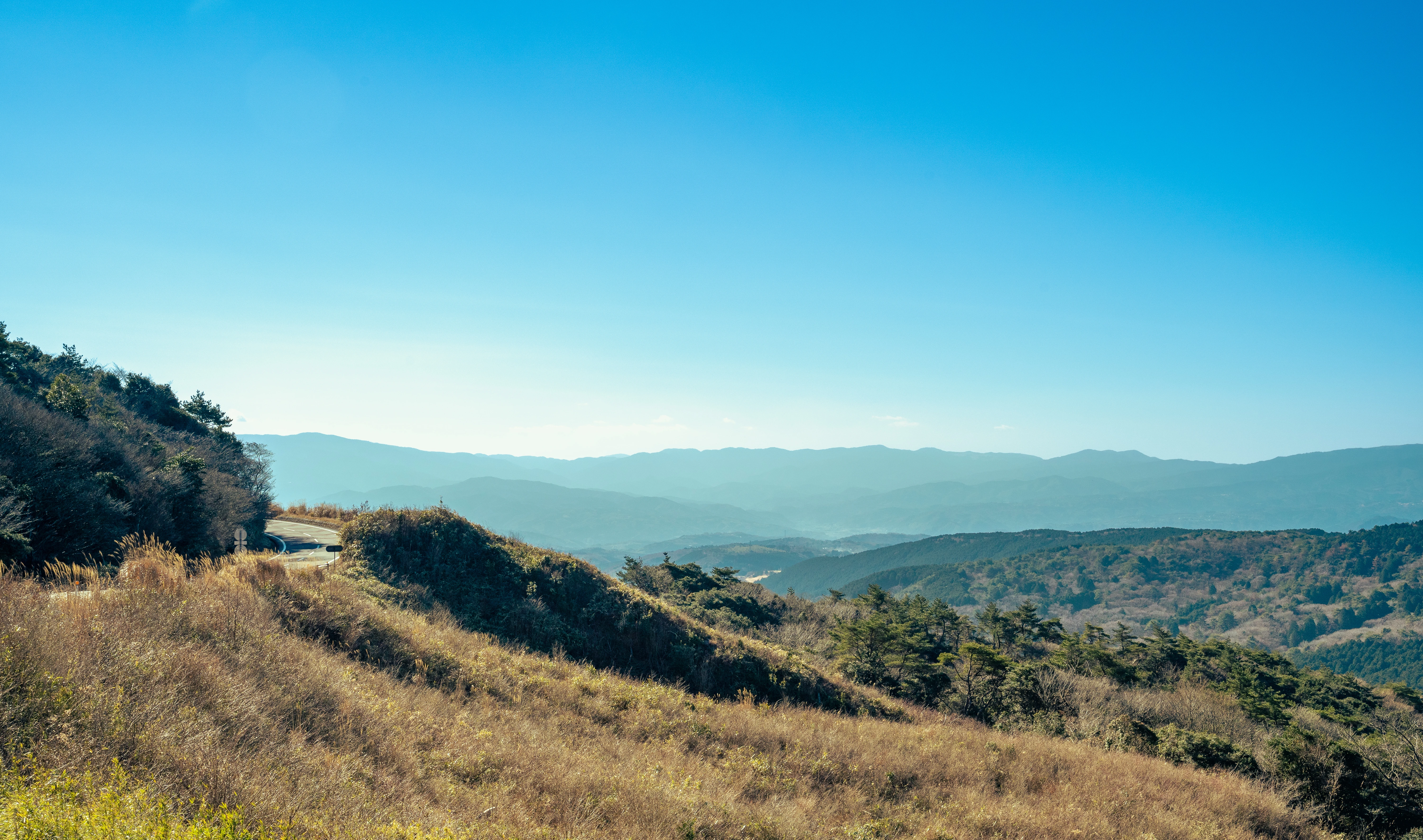 Winding Mountain Road Under the Clear Blue Sky
