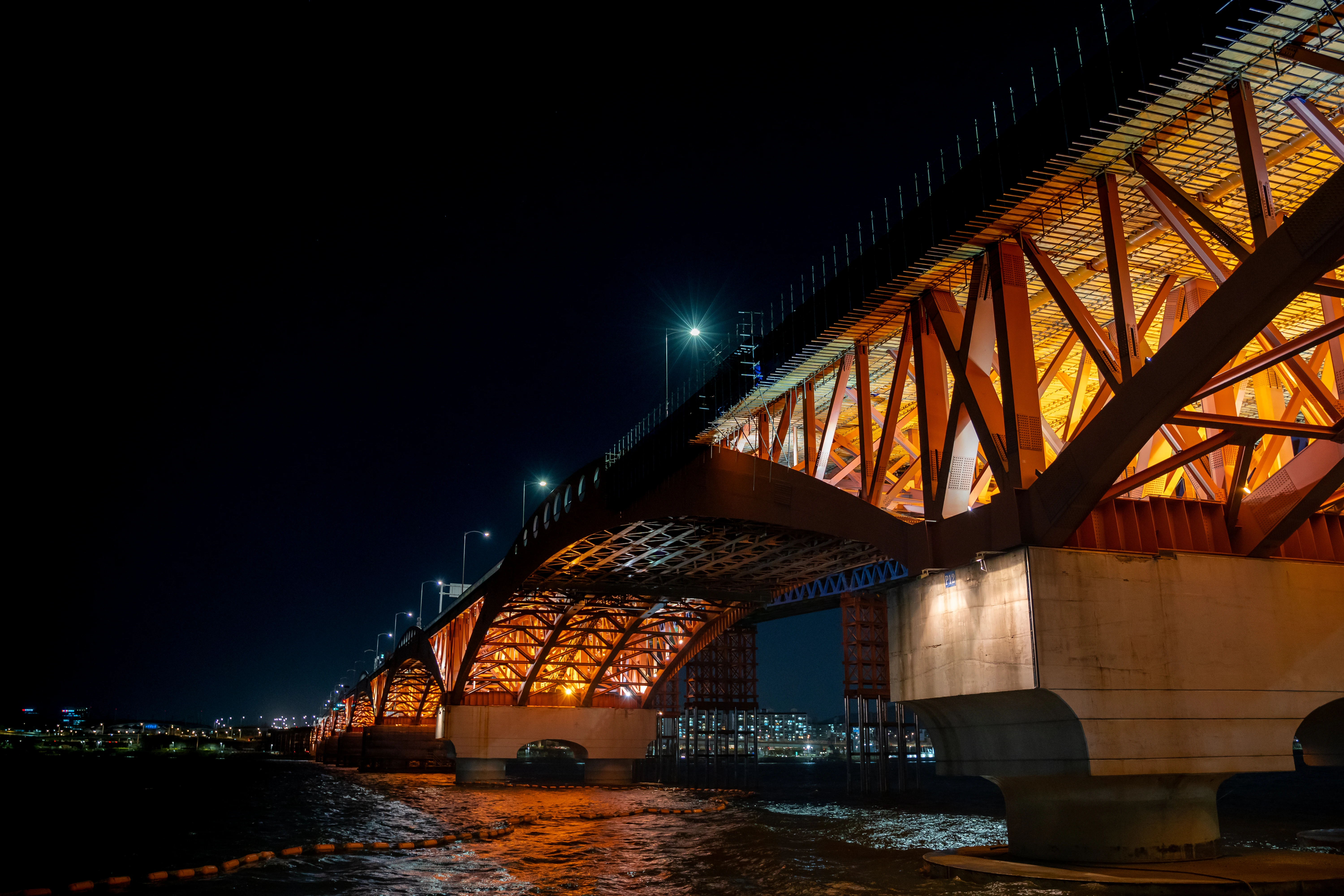 Illuminated Bridge Over the River at Night