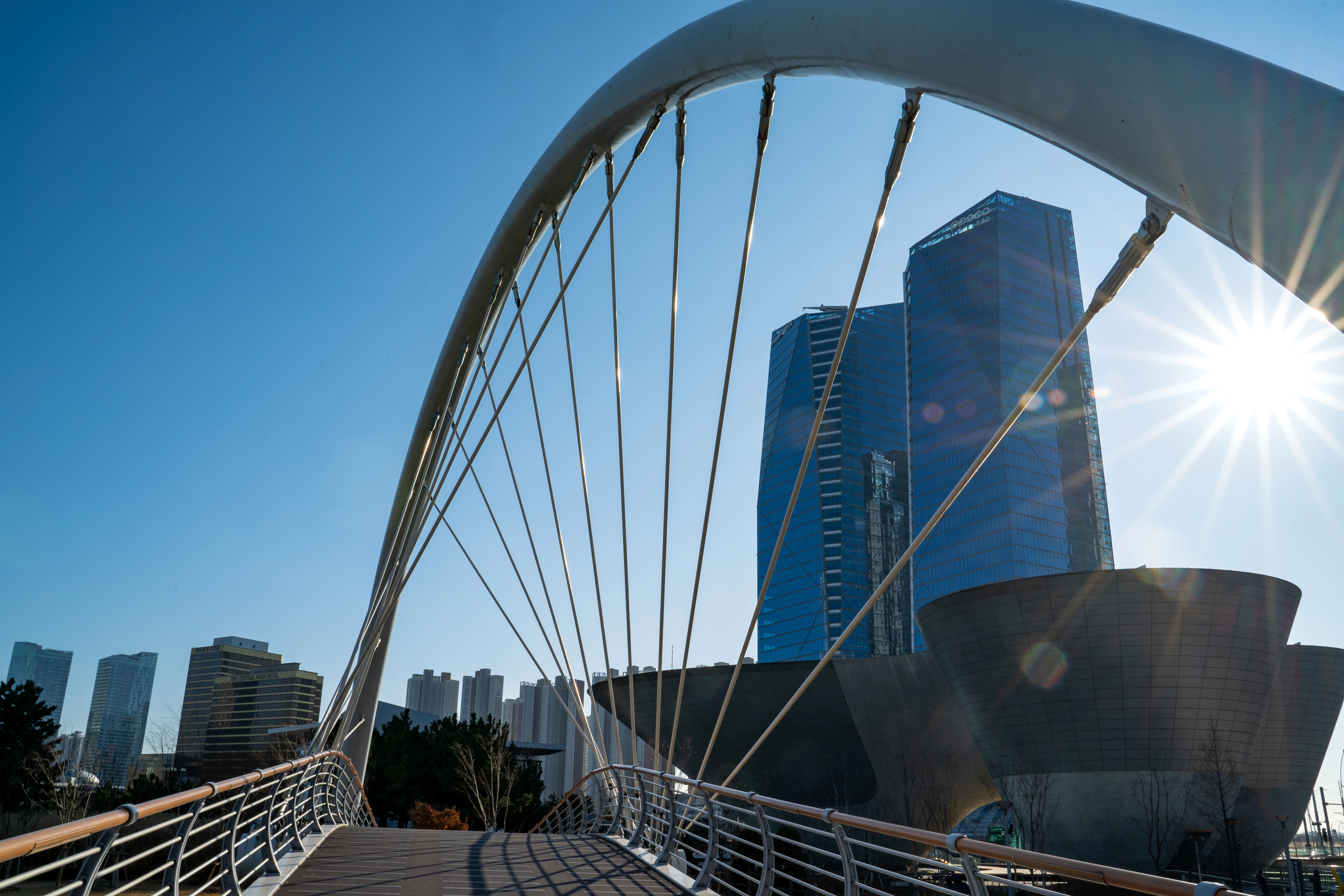 Futuristic Architecture with Sunlit Bridge and Skyscrapers