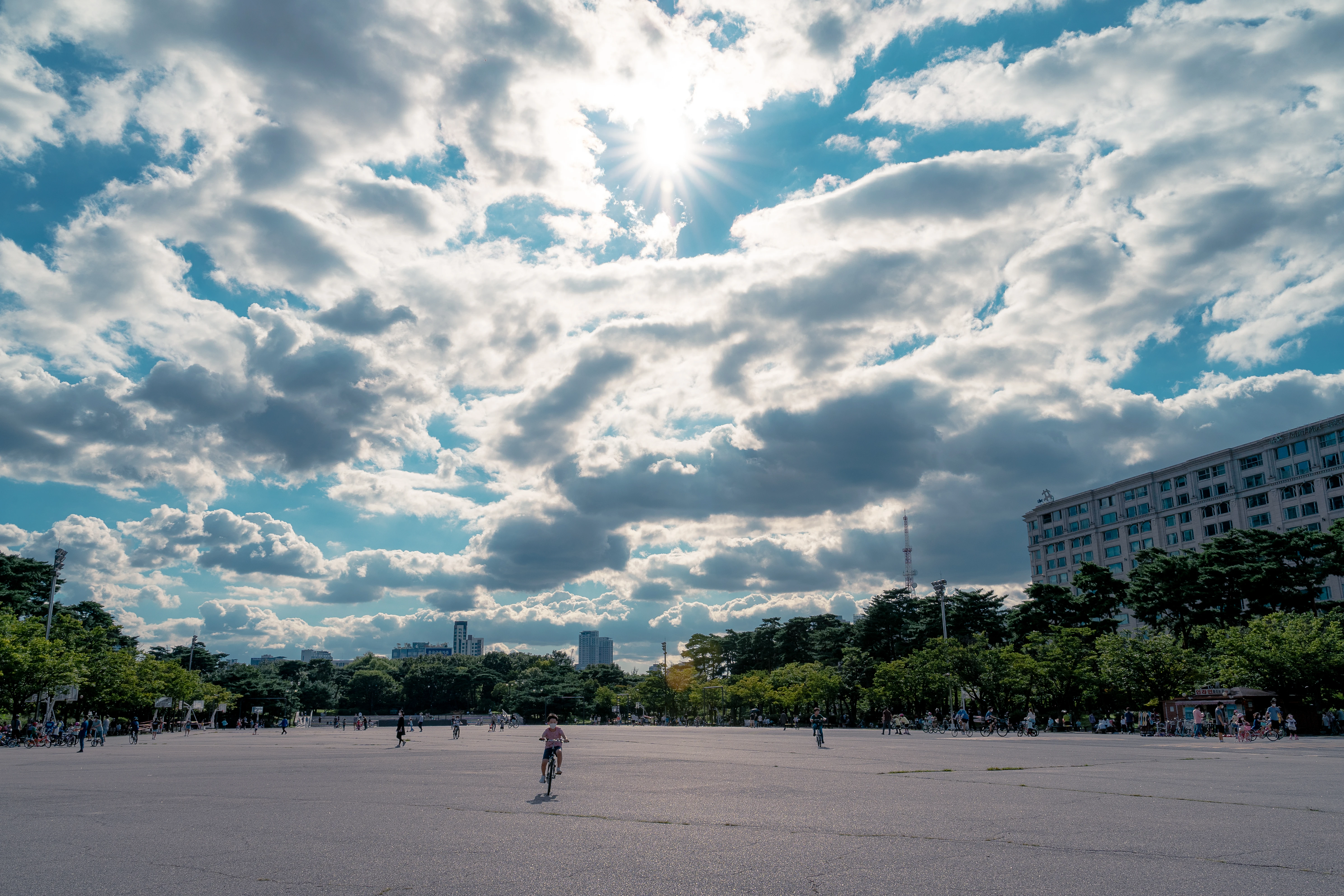 Bright Afternoon in the Open Plaza with Playful Clouds