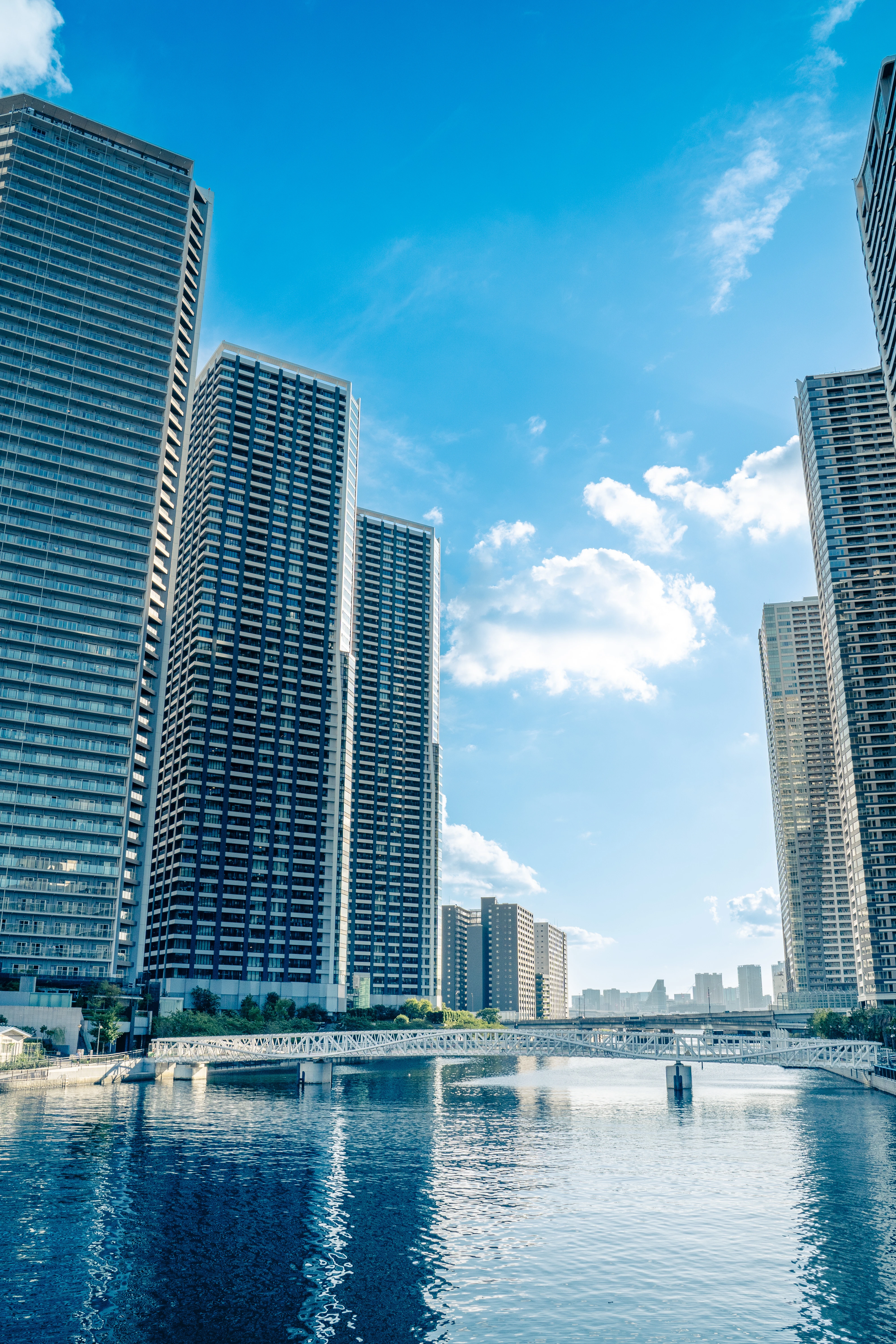 Urban Waterfront Skyscrapers under a Vibrant Blue Sky