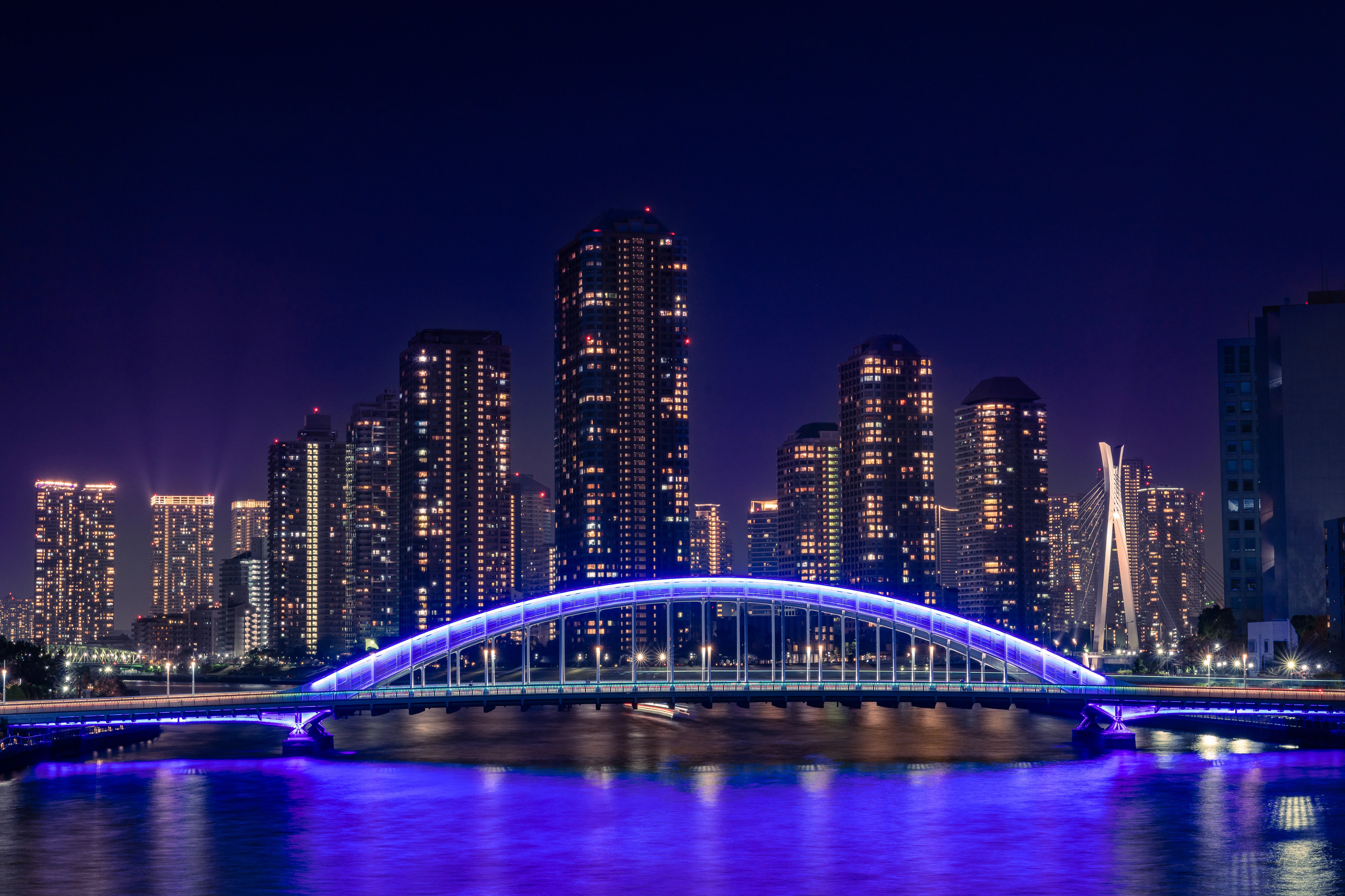 Illuminated Bridge Amidst Tokyo's Night Skyline