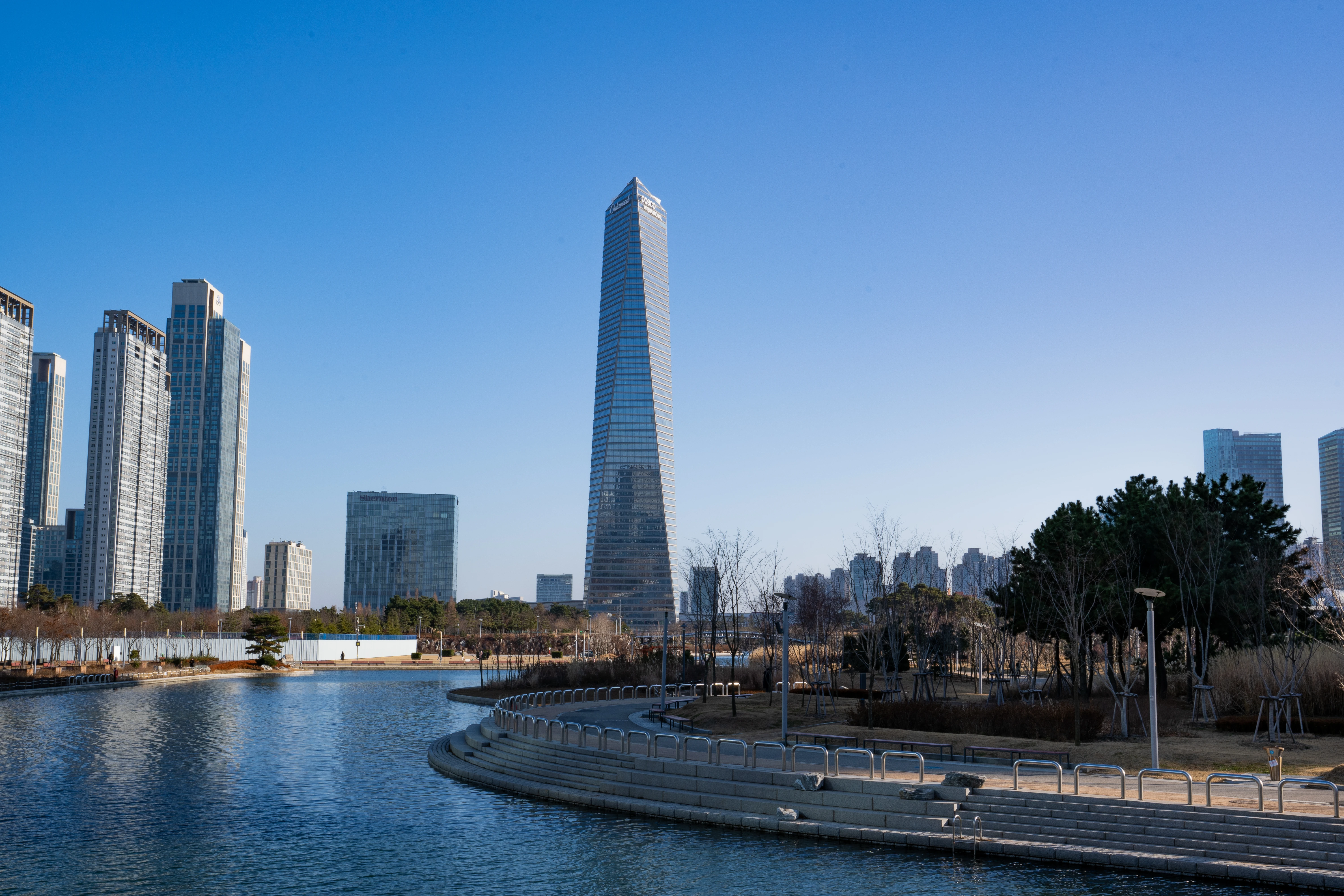 Songdo's Towering Presence by the Tranquil Water