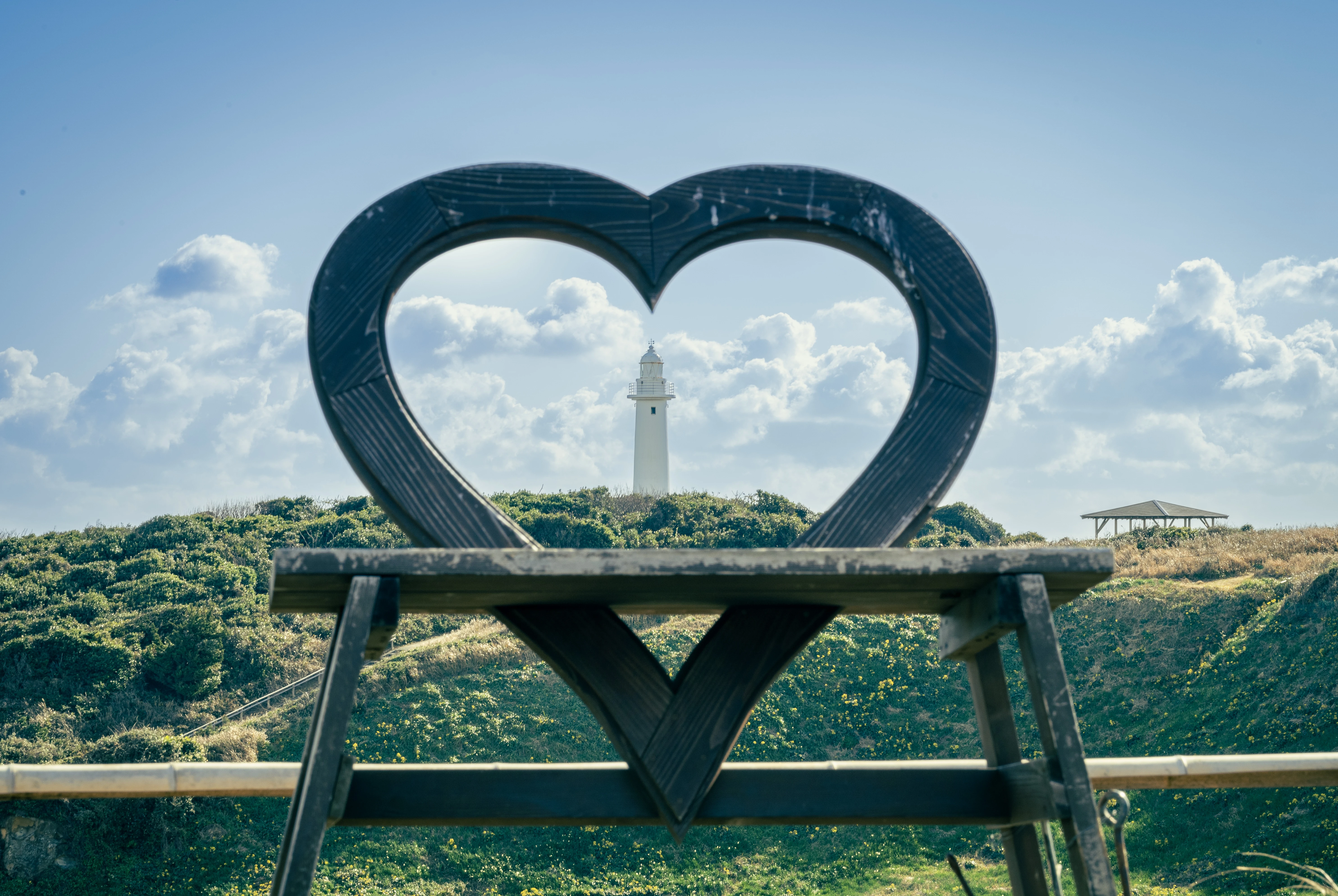 Lighthouse Framed by Heart on a Sunny Hill