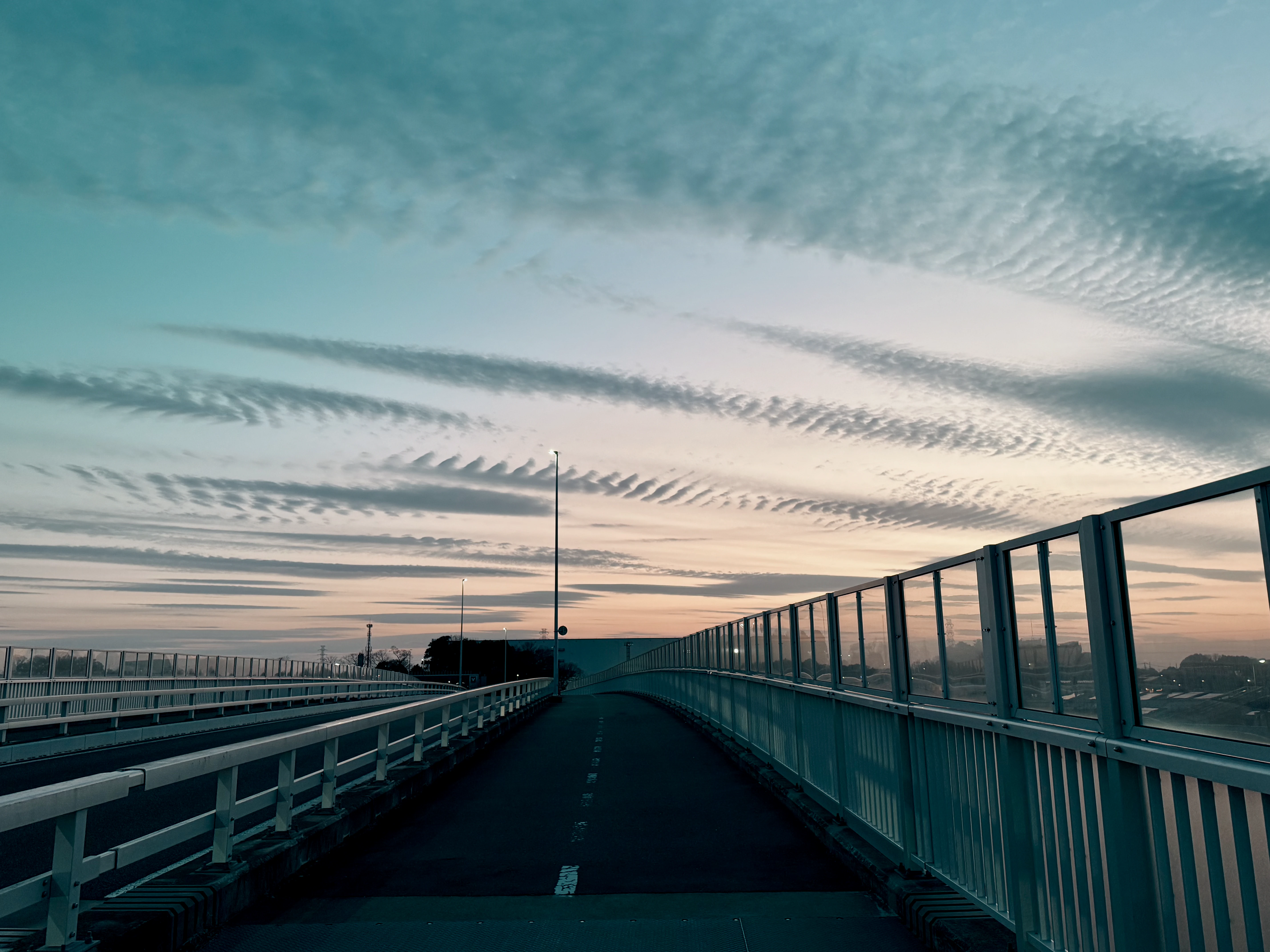 Rippling Clouds Over a Quiet Urban Bridge