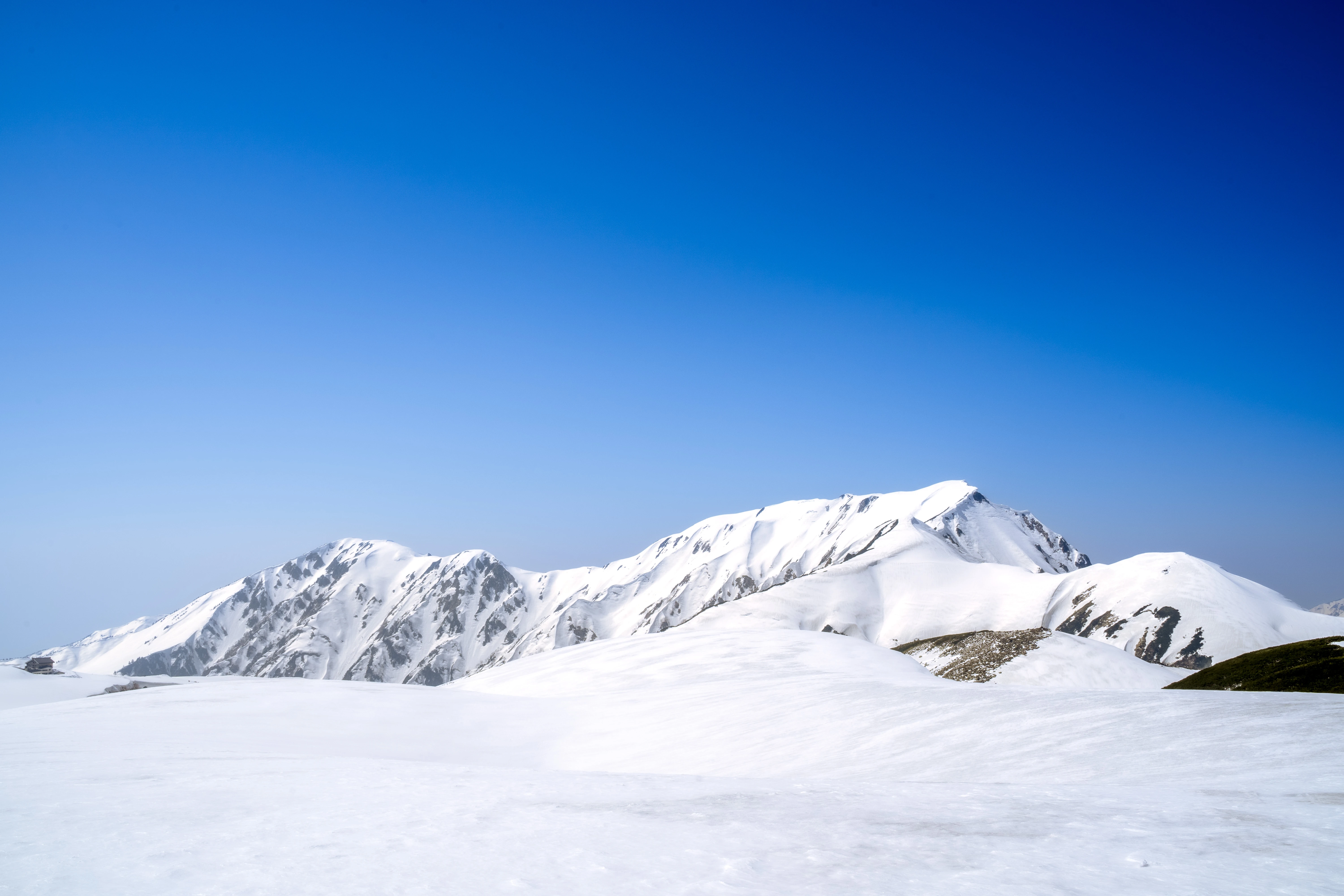 Crystal Clear Spring Sky Over Snow-Covered Alpine Peaks