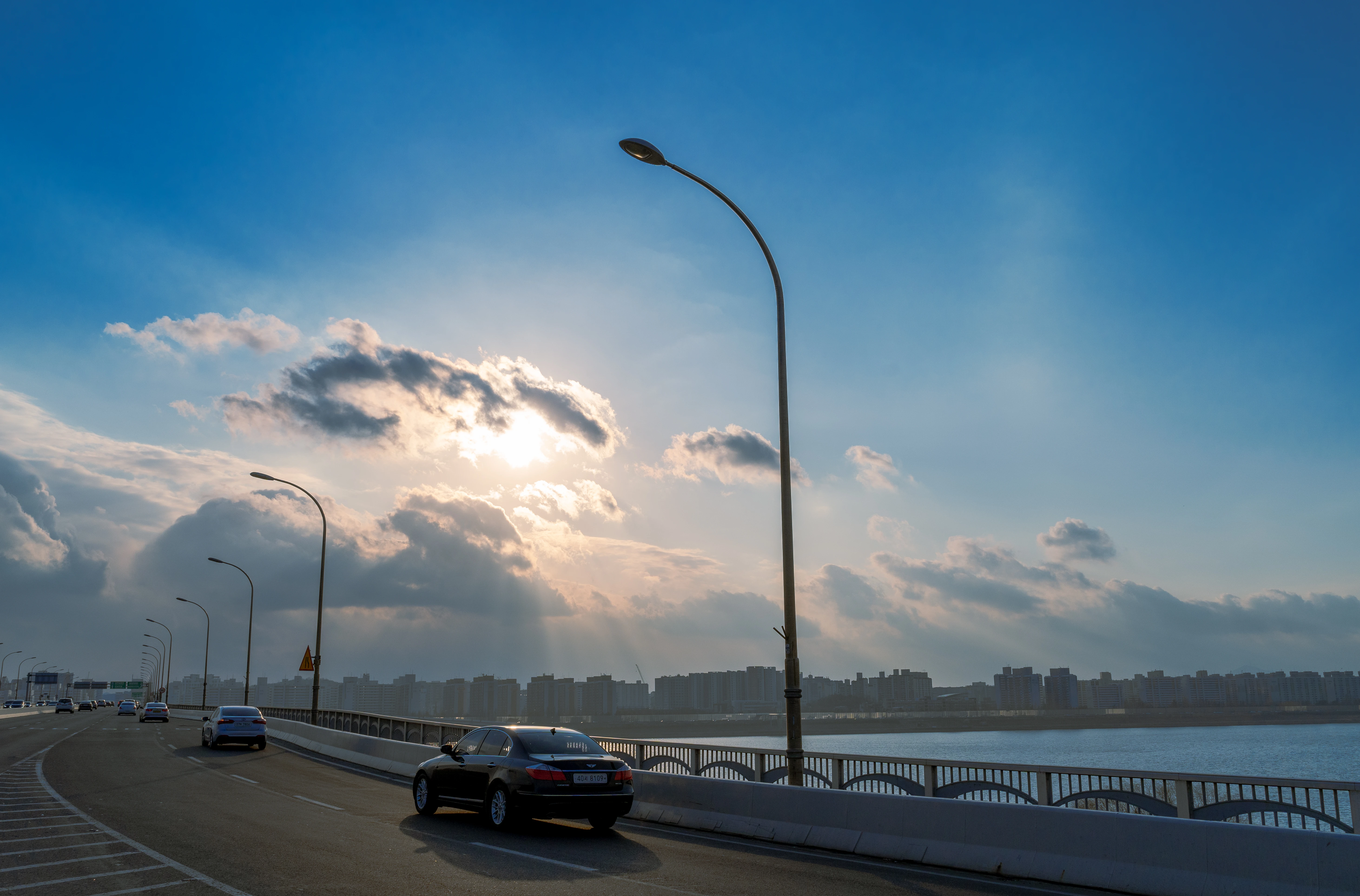 Sunlit Bridge Drive Under a Vast Blue Sky