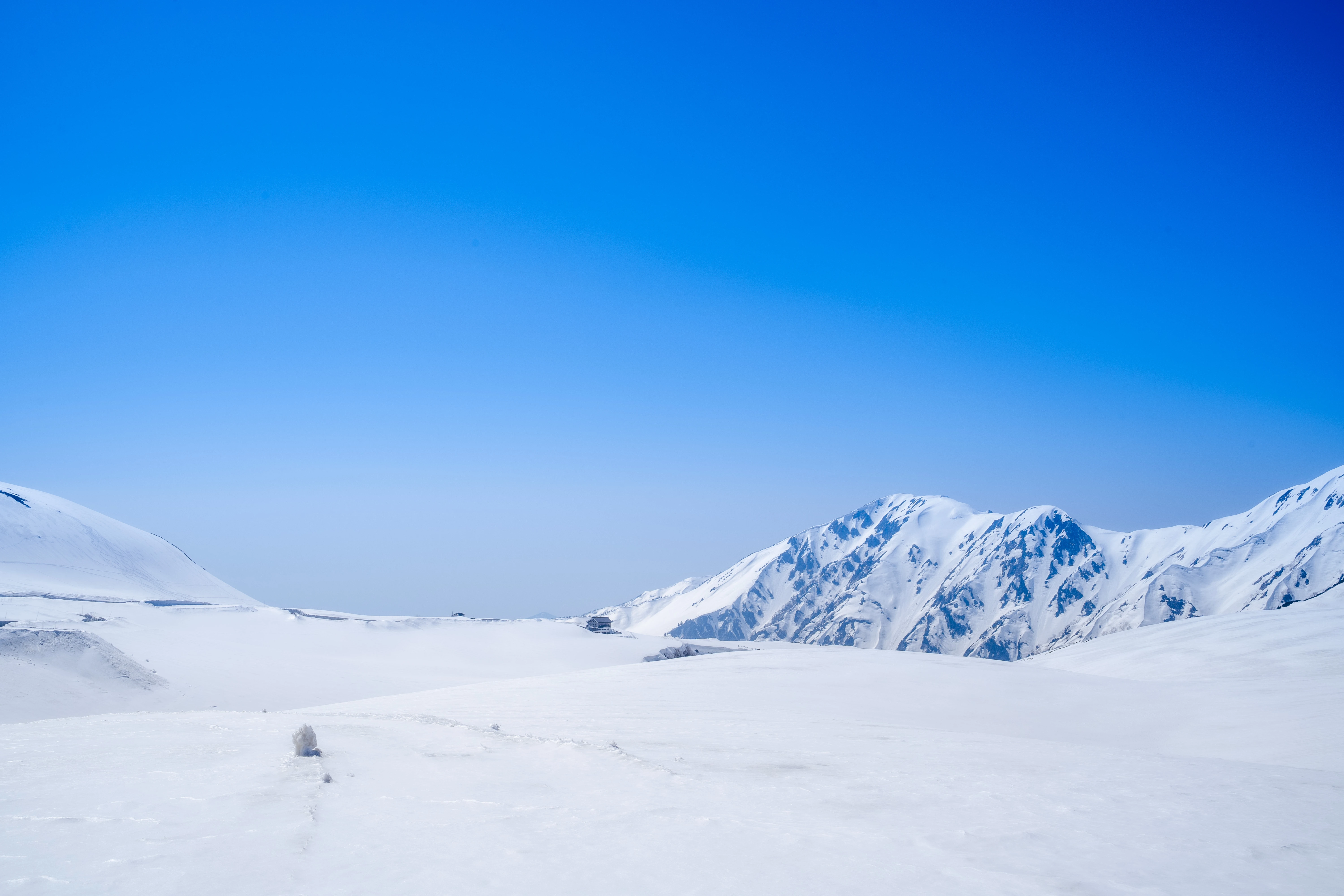 Crystal Clear Spring Sky Over Tranquil Snow-Covered Peaks