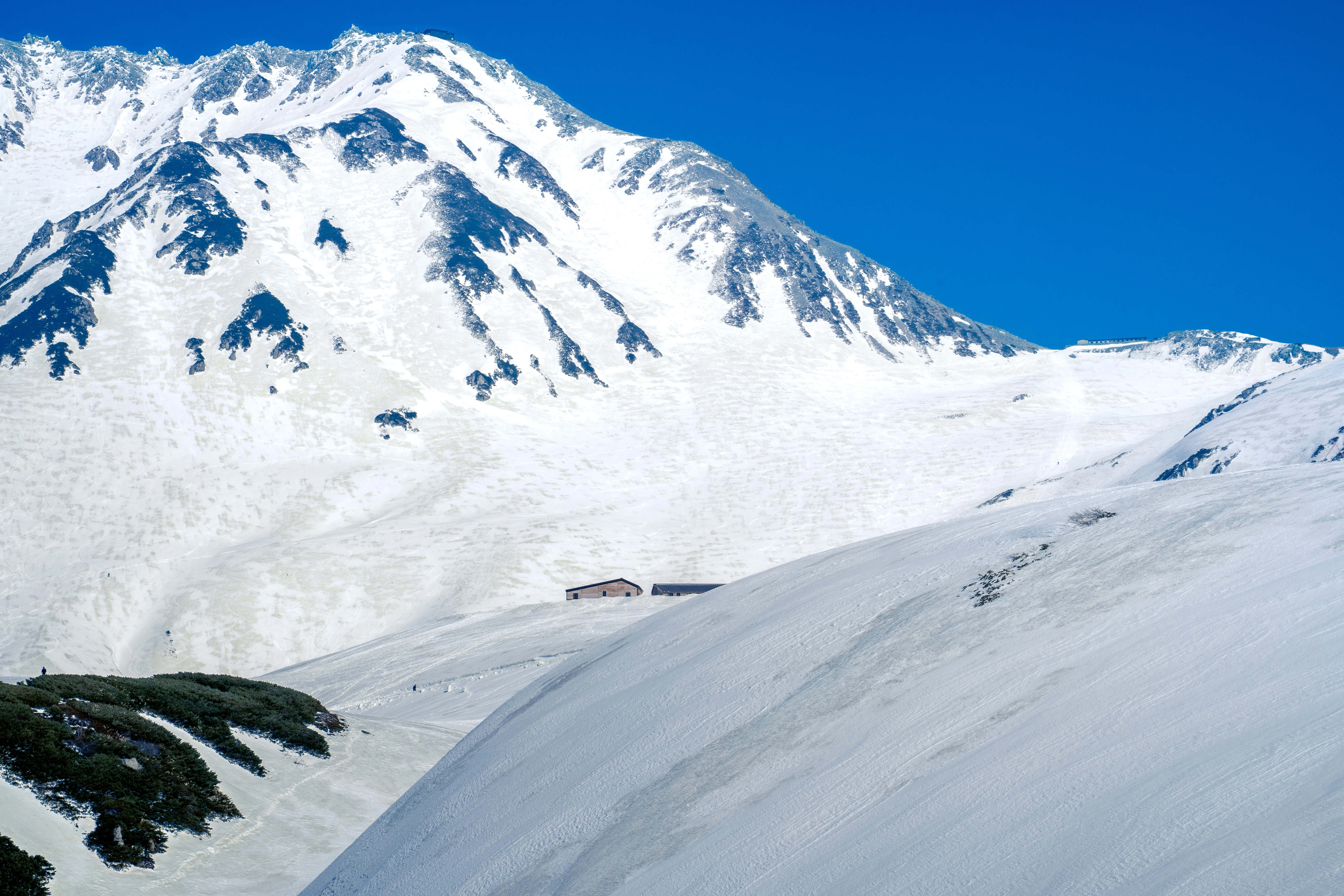 Pristine Snowy Peaks Under Crisp Blue Sky in Late Spring