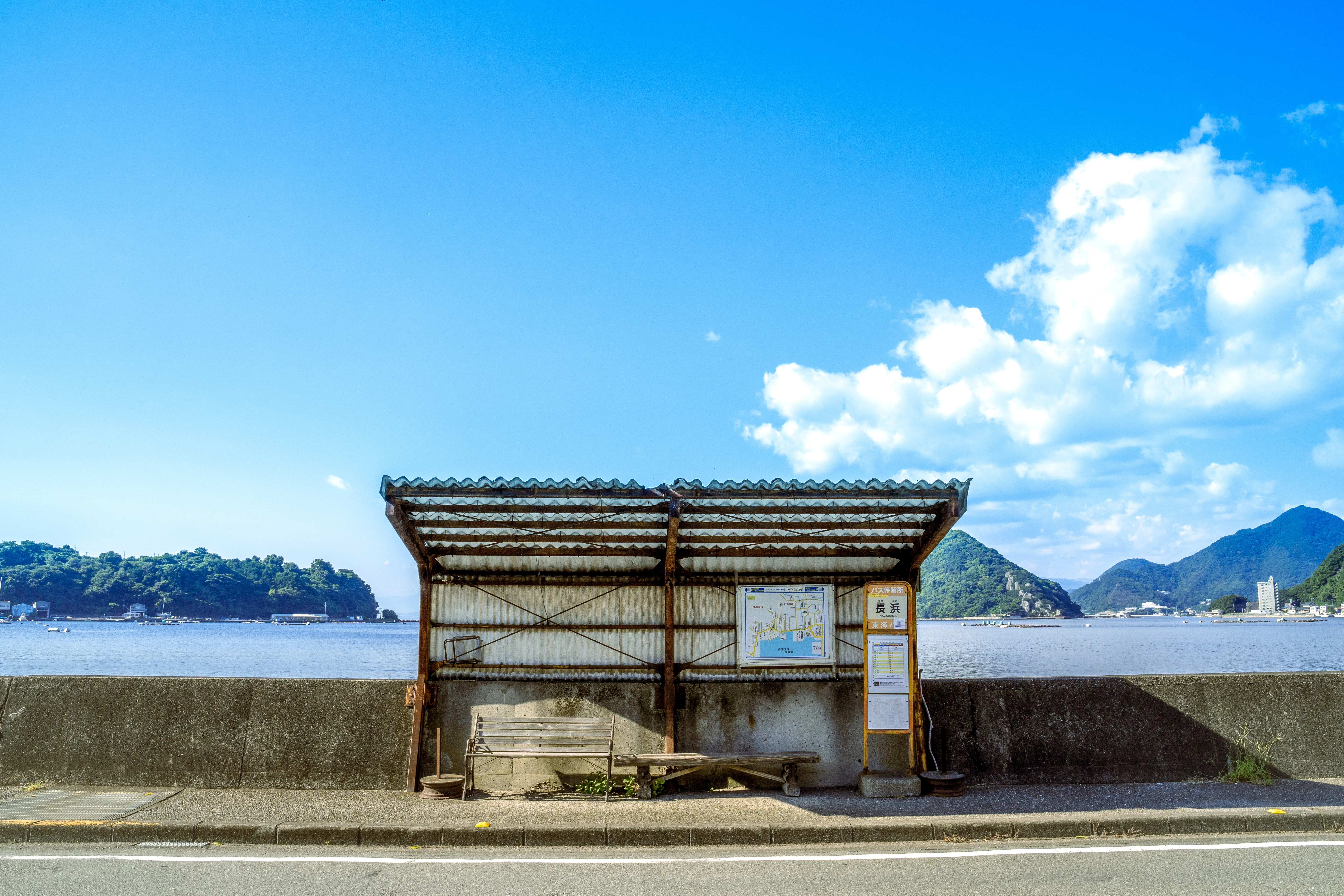 Seaside Bus Stop Under a Vibrant Blue Sky