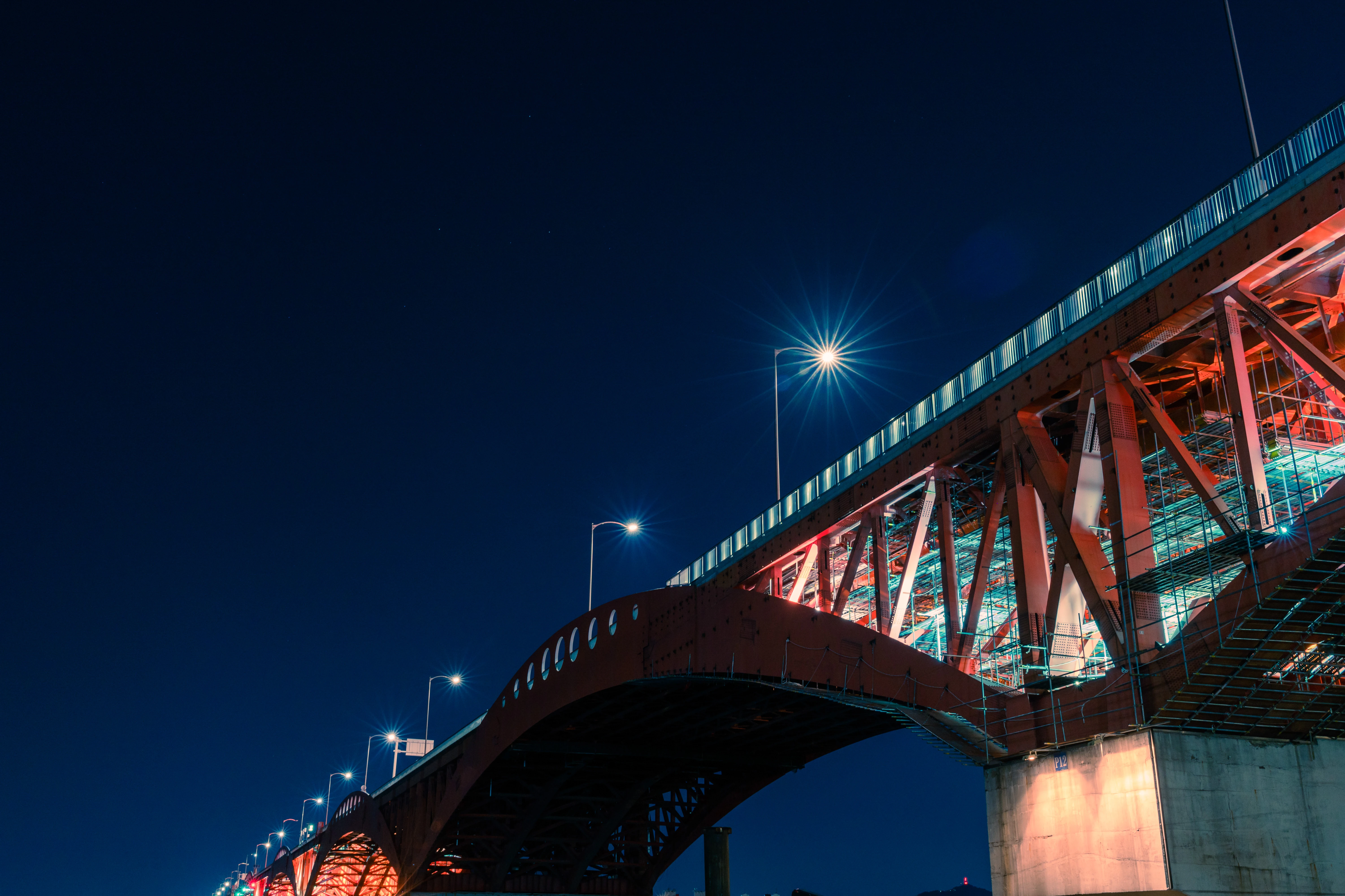Illuminated Steel Bridge Against the Midnight Sky