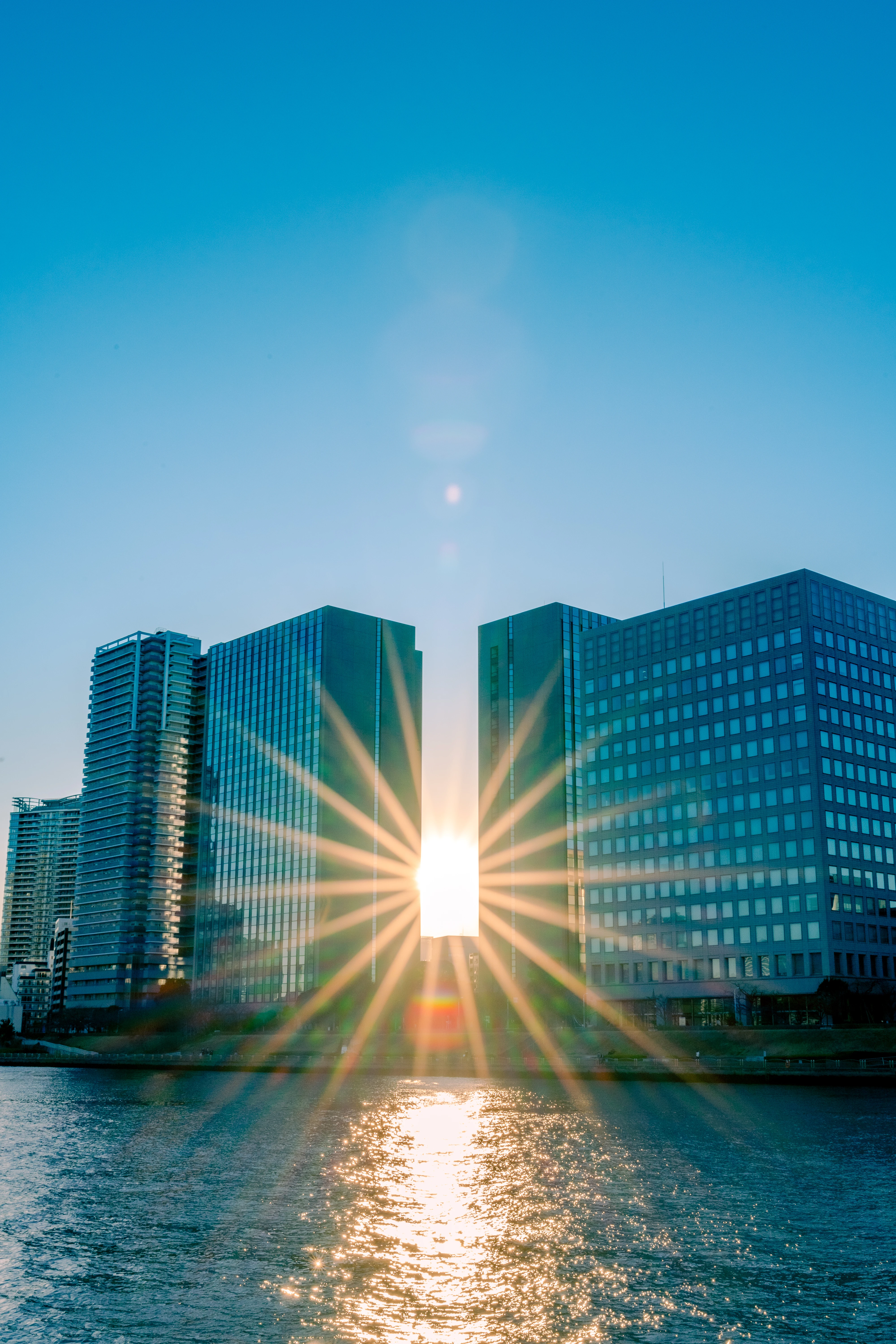 Radiant Sunrise Through Urban Towers