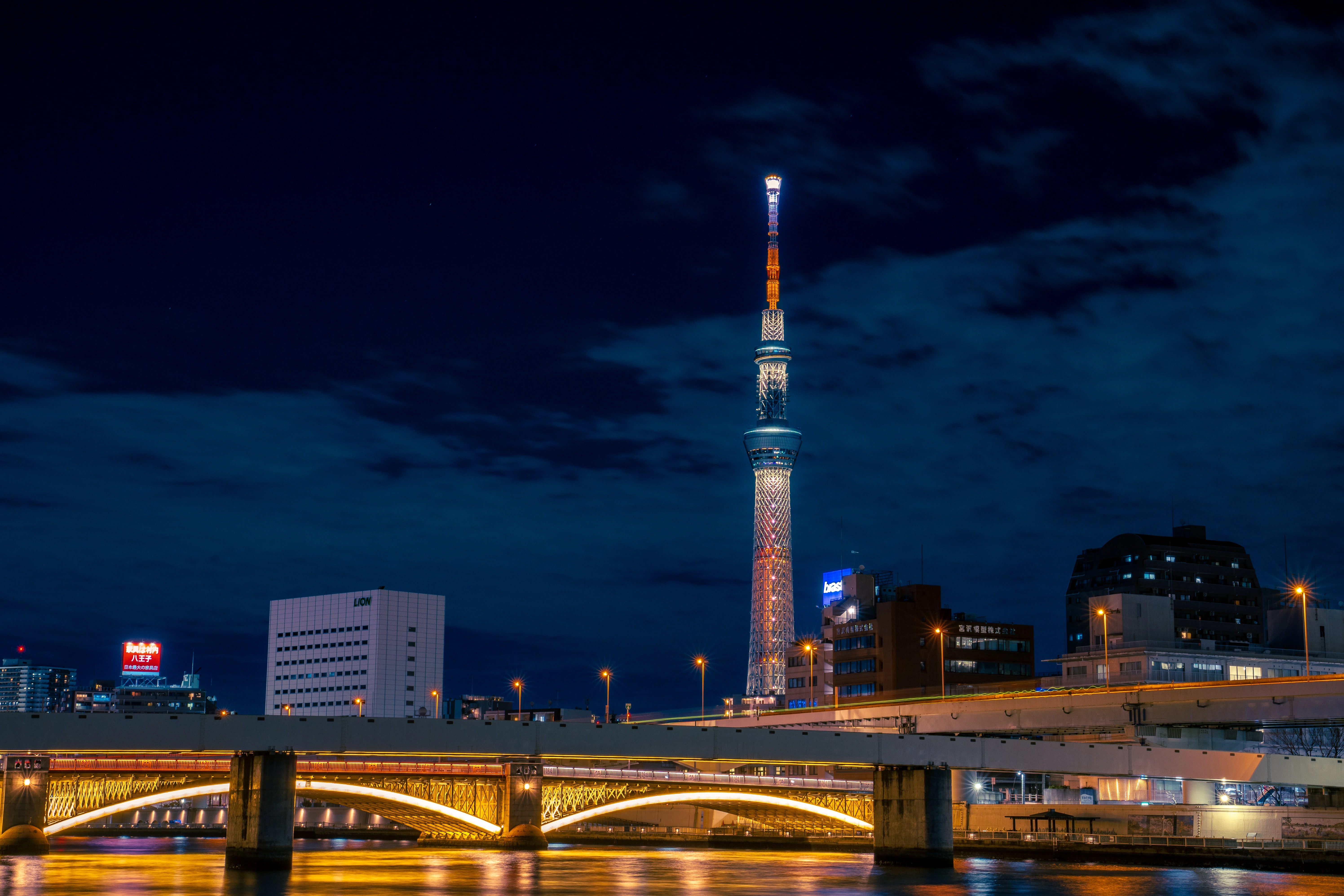 Tokyo Skytree Illuminated Over a Nightlit Bridge