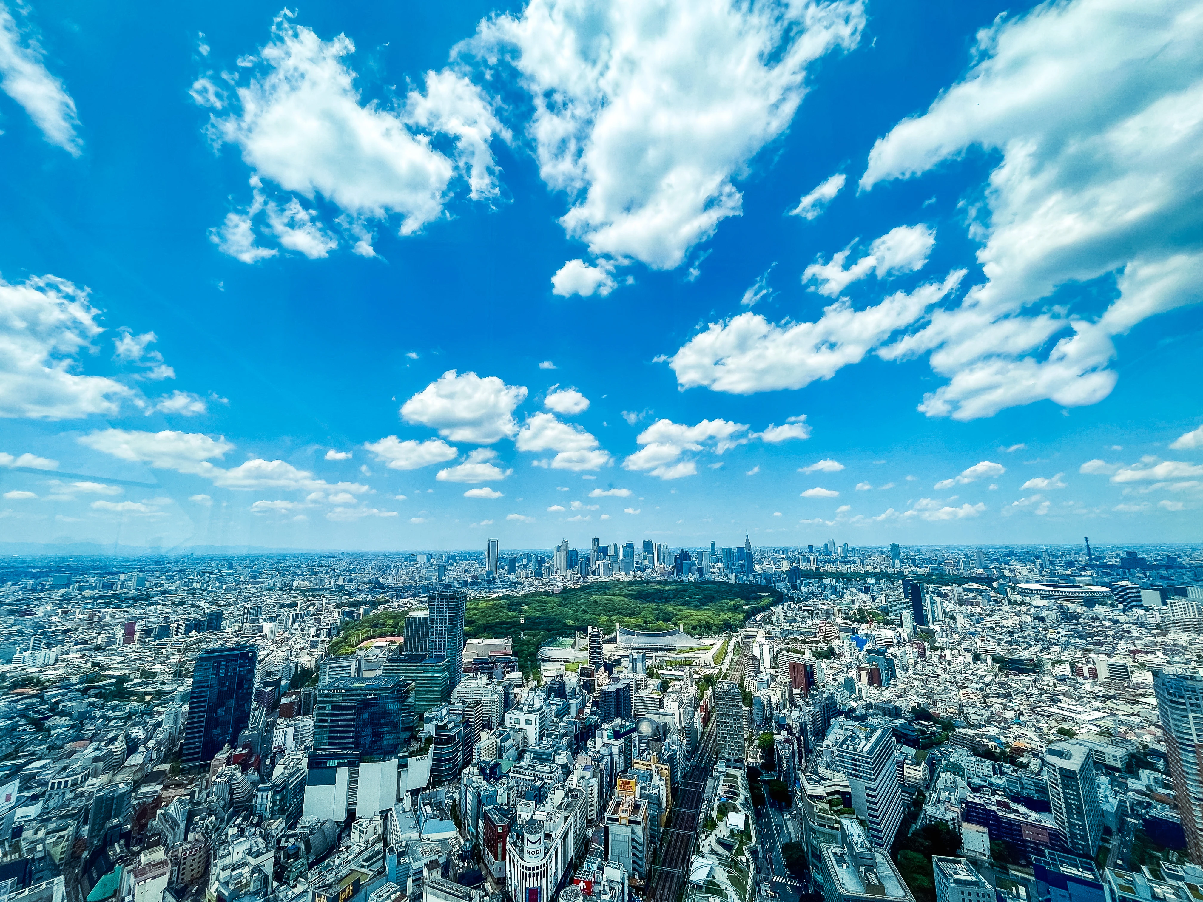 Vibrant Aerial View of Tokyo Under a Bright Blue Sky