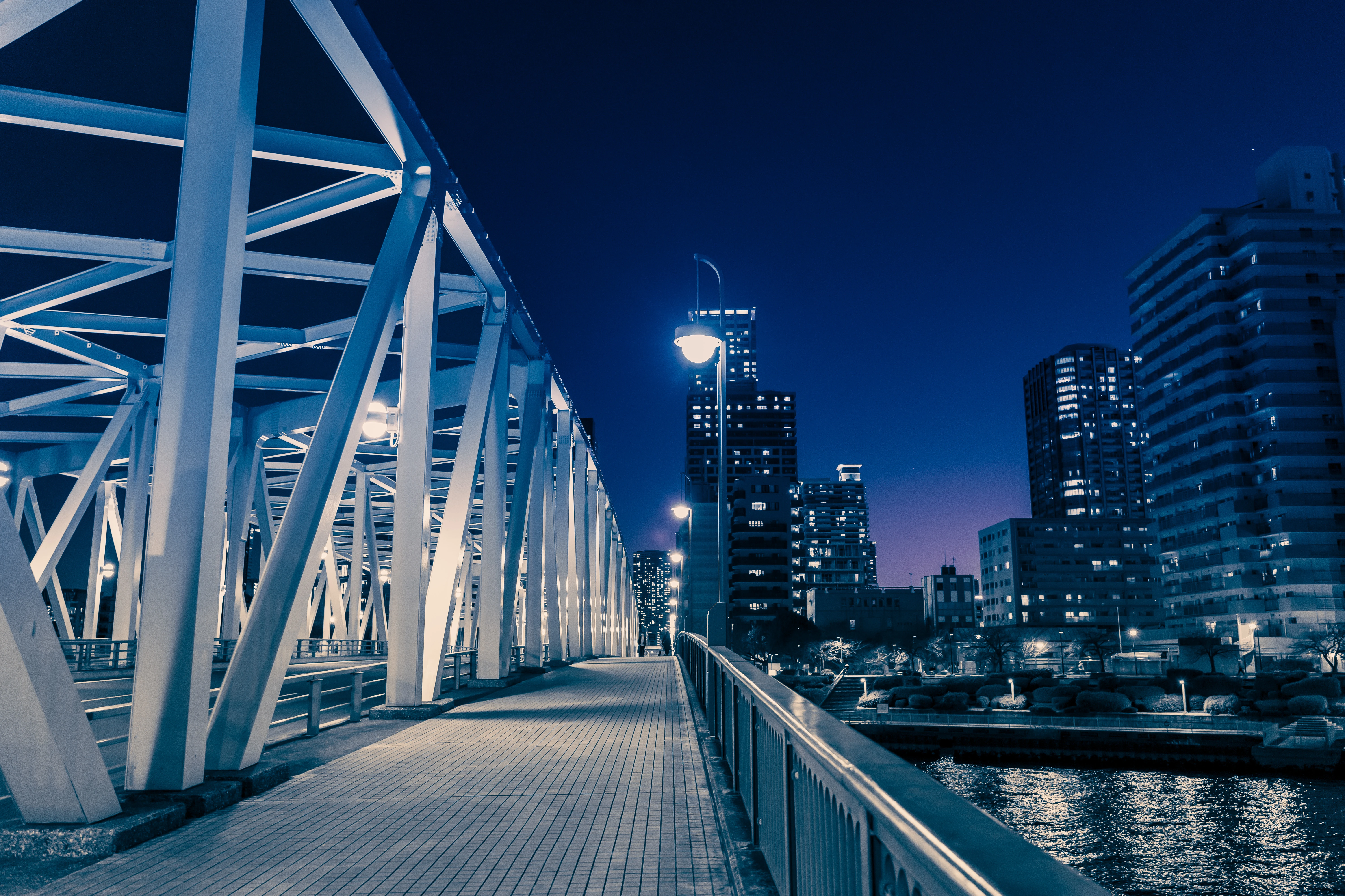 Illuminated Bridge Leading to a Vibrant City Skyline at Dusk