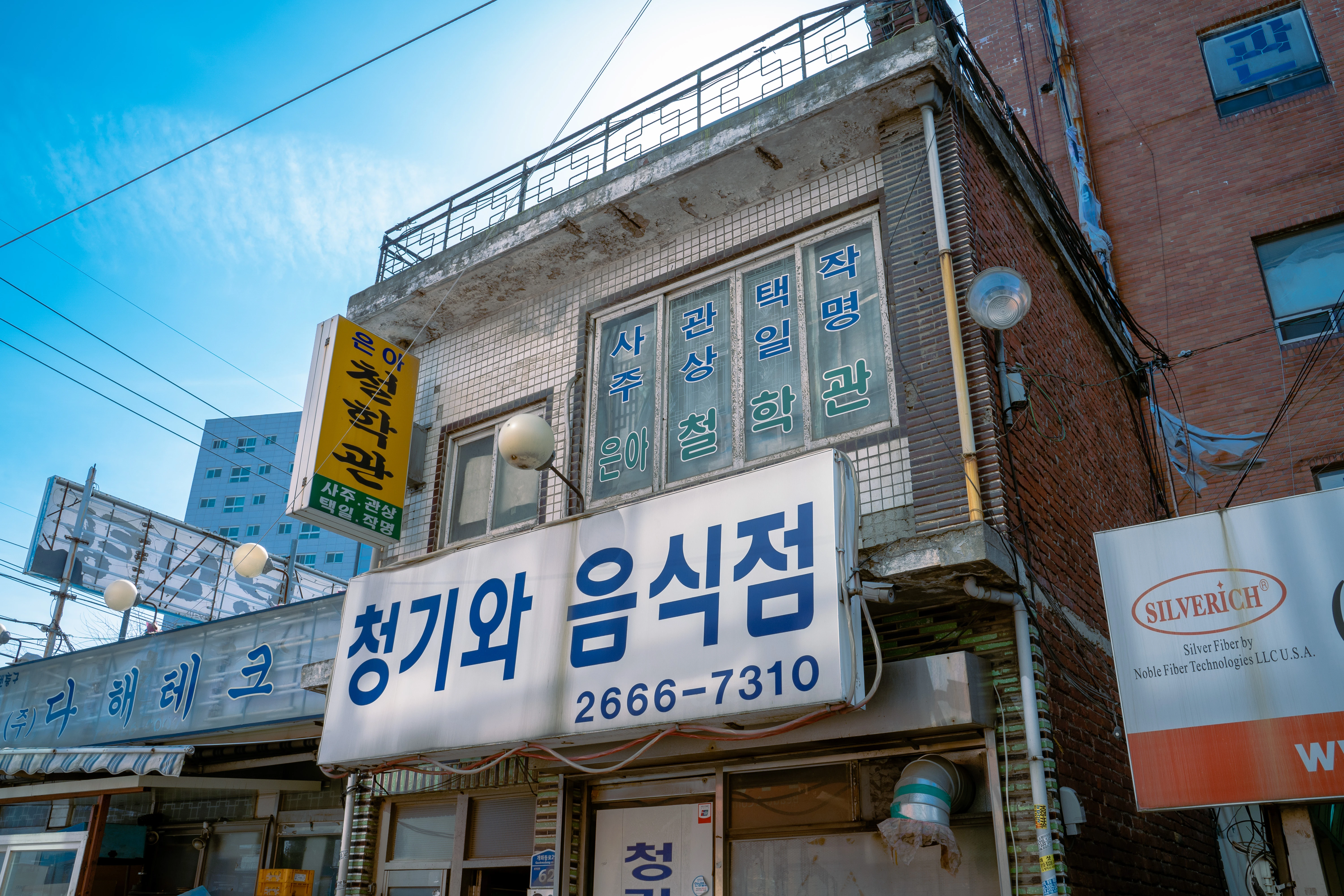 Sunny Street View of Retro Korean Storefronts