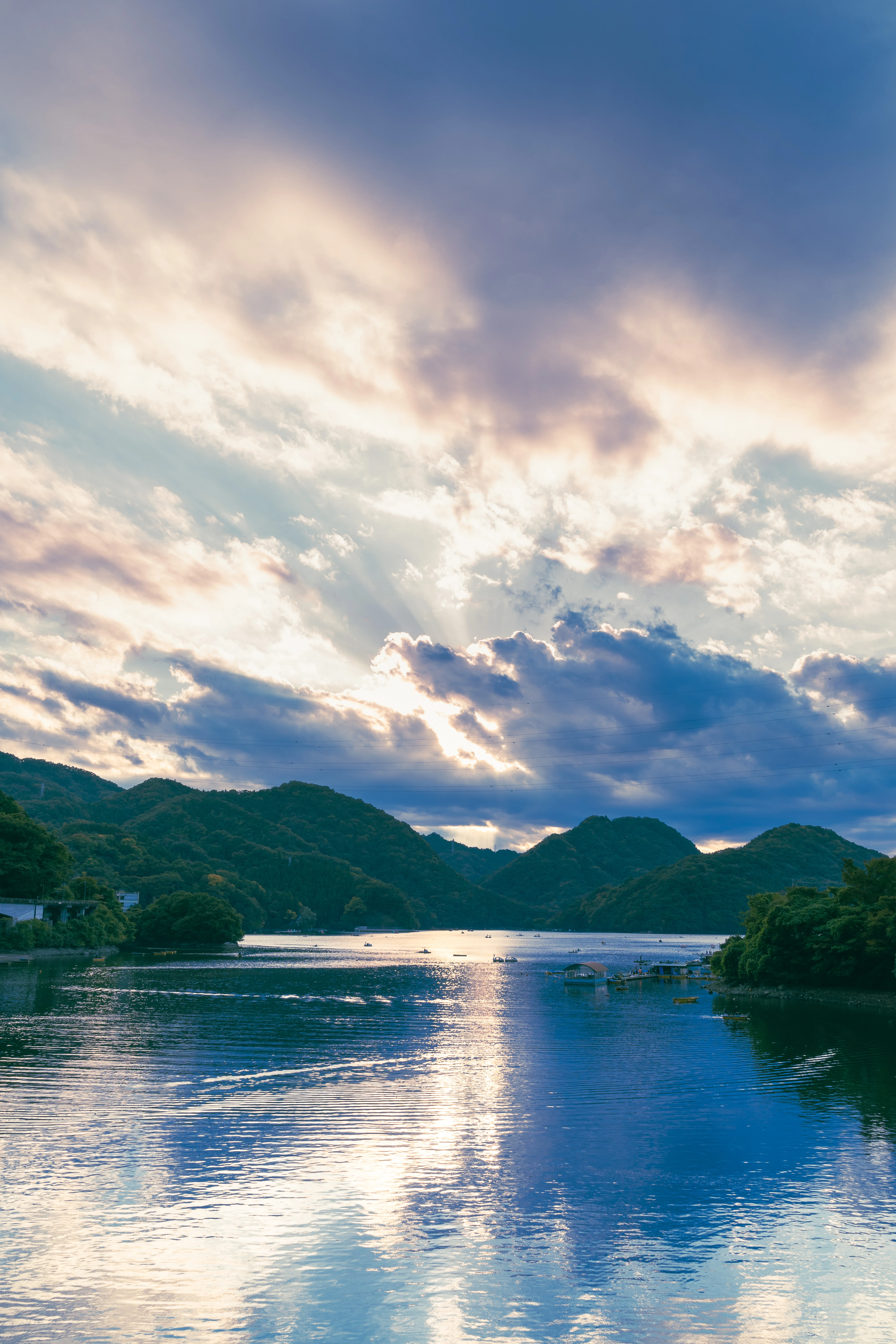 Tranquil River at Dawn with Majestic Hills and Radiant Cloudscape