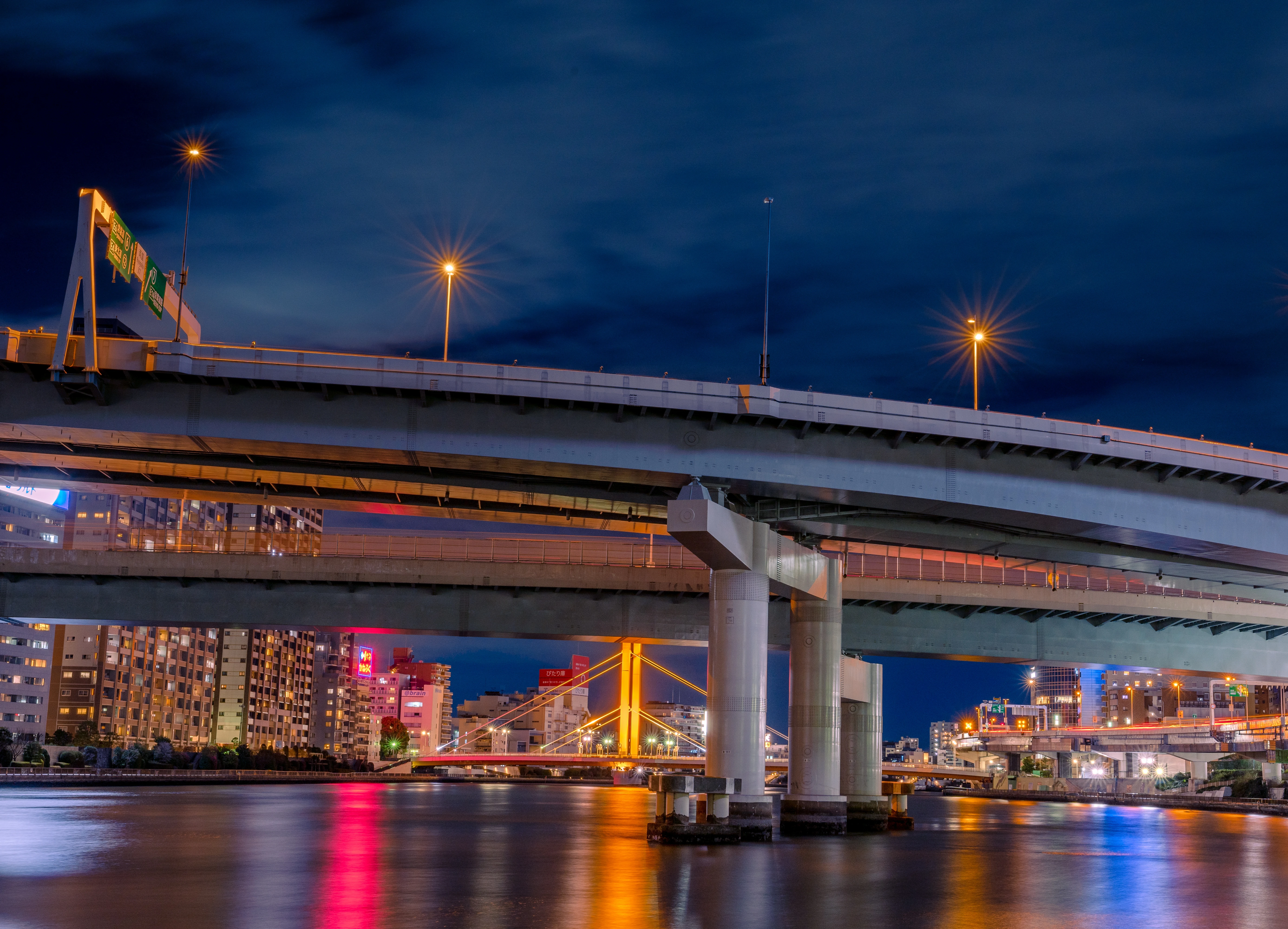 Vibrant Urban Bridges Illuminated at Night