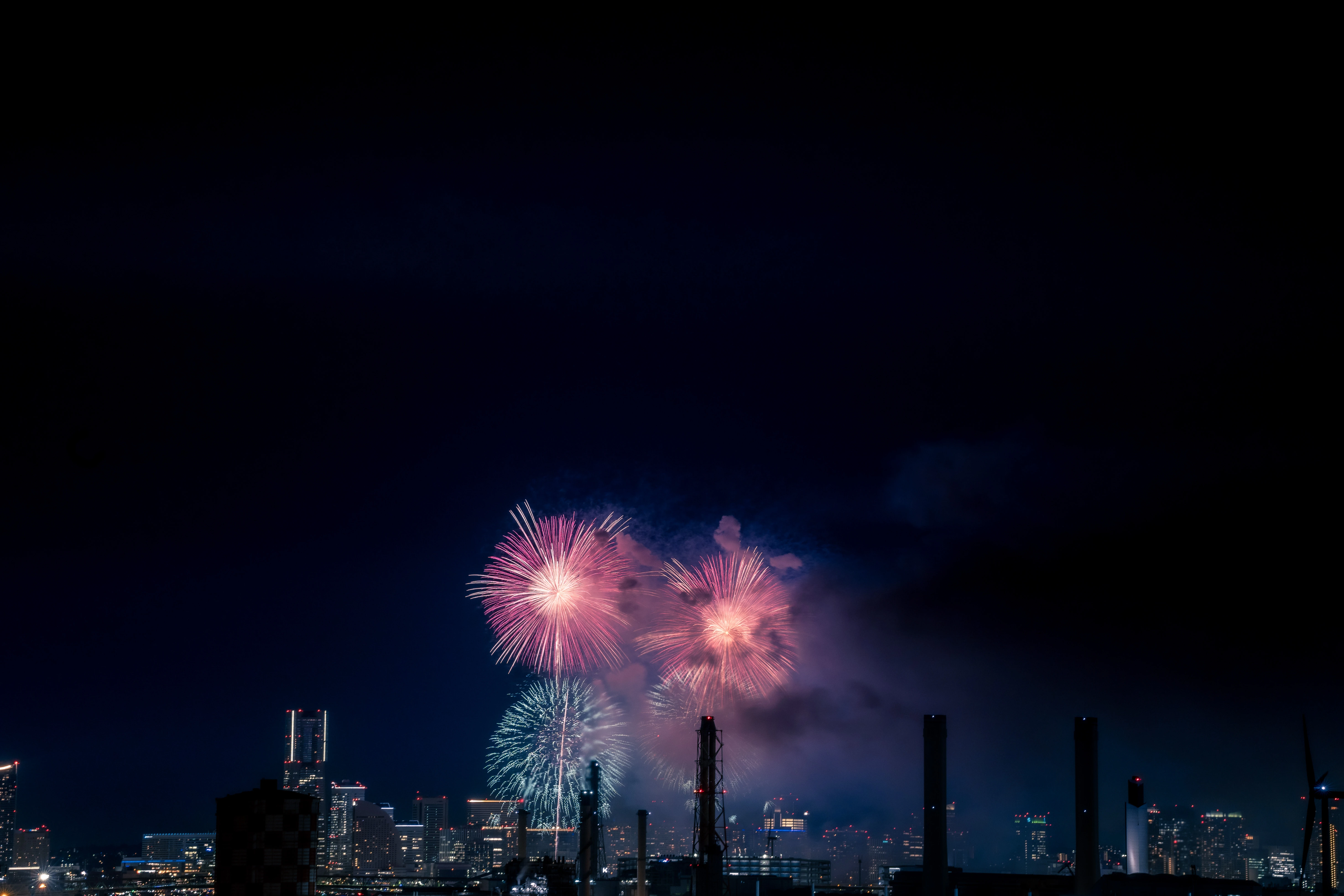 Vivid Fireworks Illuminating a City Skyline at Night